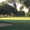 A sunny day view of a green at Mather Golf Course.