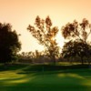 A sunset view of a green at Los Serranos Country Club.