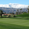 A view of a green and snowy mountains in background at Desert Falls Country Club.