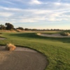 View of a green and bunker at Dragonfly Golf Club.