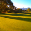 A sunny view of green with cart path in background (courtesy of Diablo Creek Golf Course)