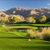 A view of a green with water coming into play