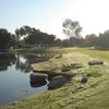 A sunny view of green with water coming into play at Skylinks Golf Course