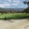 A view of the practice putting green with mountains in background at Soule Park Golf Club