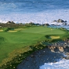 Aerial view of green #14 surrounded by water at Dunes Course