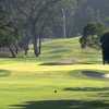 A sunny view of green protected by bunkers at Rancho Santa Fe Golf Club