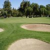 A view of a green protected by bunkers at Arrowhead Country Club