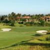 A view of a green guarded by bunkers at Santaluz Club