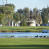View of a green and pond at Desert Trail RV Resort & Golf Course
