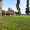 A view of a green and clubhouse at Airways Golf Course