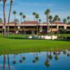 A view of a green with water coming into play and the clubhouse in background at Mission Hills CC