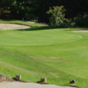 A view of a green protected by tricky sand traps at Chevy Chase Country Club
