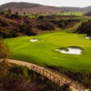 A view of a green guarded by tricky sand traps at Shady Canyon Golf Club