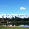 A view from a green with mountains covered with snow at Oak Valley Golf Club