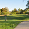 A view of a hole flanked by tricky sand traps at Haggin Oaks Golf Course