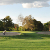 A view of a green guarded by sand traps at Haggin Oaks Golf Course