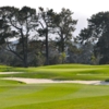 A view of a green protected by bunkers at Monterey Pines Golf Club
