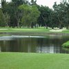 A view of a green with water in foreground at Corica Park.
