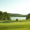 A view of a green with water in background at Auburn Valley Golf Club