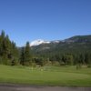 A view of the practice putting green and the driving range in the distance at Plumas Pines Golf Resort