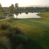 A green view with water in the background and narrow road on the left at Sterling Hills Golf Club