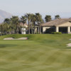 A view of a green  with the clubhouse in background at Sierra Lakes Golf Club.