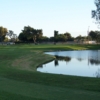 A view from Meadowlark Golf Course with golf carts in background and water on the right.