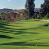 A view from Oak Creek Golf Club with clubhouse in background and bunkers on the right
