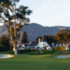 A view of a green flanked by sand traps and the clubhouse in background at Valley Club of Montecito