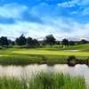 A green view with water on the right at The Lincoln Hills Golf Club