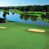 Aerial view of a green surrounded by bunkers with water in background at El Dorado Park Golf Club