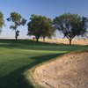 A view of a green with a huge bunker on the right at Mather Golf Course.