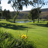 A view of the practice putting green at Oceanside Golf Course with water in background