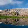 A view over the water of the clubhouse at South Course from Indian Canyons Golf Resort.