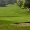 A view of a green with a bunker on the right at Mountain Meadows Golf Course.