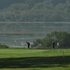 A view of a green with water in background at Pajaro Valley Golf Club