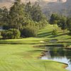 A view of a green with water on the right at Blue Rock Springs Golf Course