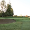 A view of a green guarded by a bunker at Grape Ranch Golf Club.