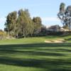 A view of a hole and the clubhouse in background at Tijeras Creek Golf Club.