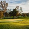 A sunny day view of a hole at Oaks North Golf Course.