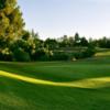 A sunny day view of a green at Jurupa Hills Country Club.