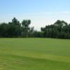 A sunny day view of a hole at Los Verdes Golf Course.