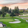 A view of a green protected by bunkers and a pond at San Joaquin Country Club.