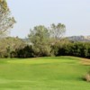 A sunny day view of a hole at Castle Oaks Golf Club.