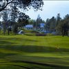 A view of the clubhouse with green in foreground at Golf Club Tierra Oaks