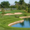 A sunny day view of a hole at Los Lagos Golf Course.