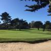 A sunny day view of a hole at Pacific Grove Golf Links.