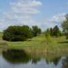 View of a green over a pond at Teleli Golf Club.