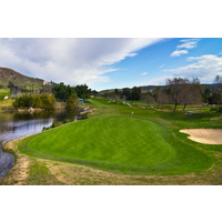 The 13th green at Tierra Rejada Golf Club is mounted in a waterfall and is protected by a sand bunker on the left.