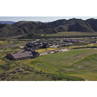 An aerial view of the clubhouse, parking lot and practice area at Lost Canyons Golf Club.
